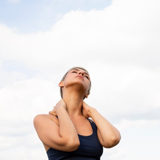 Beautiful woman stretching in nature