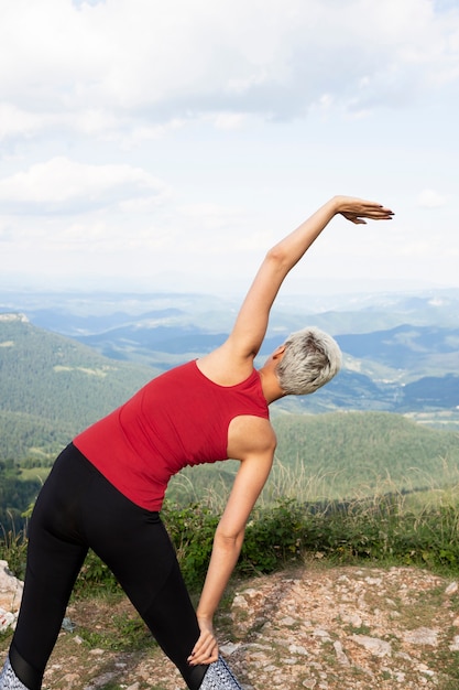 Beautiful woman stretching in nature