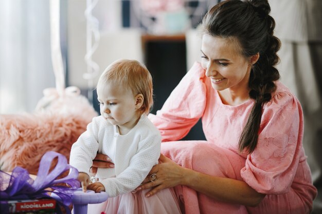 Beautiful woman supports her little daughter