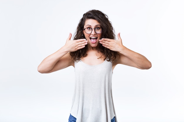 Beautiful woman surprised over white background.