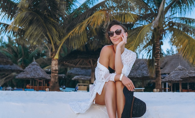 Free photo beautiful woman in swim wear by the ocean