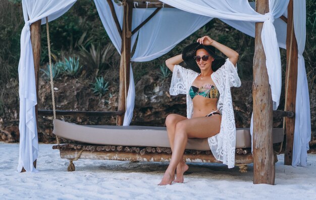 Beautiful woman in swim wear by the ocean