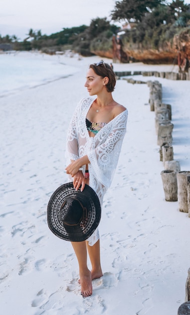 Free photo beautiful woman in swim wear by the ocean