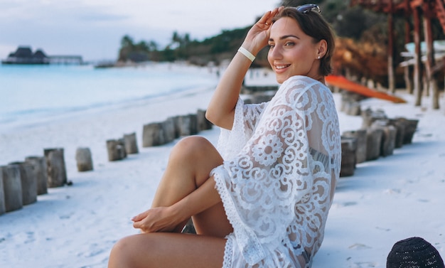 Free photo beautiful woman in swim wear by the ocean