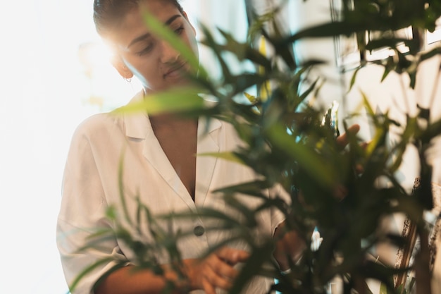 Beautiful woman taking care of  home plants