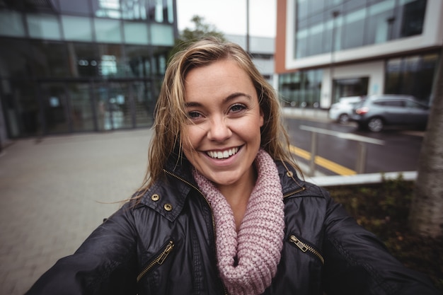 Beautiful woman taking a selfie on smartphone