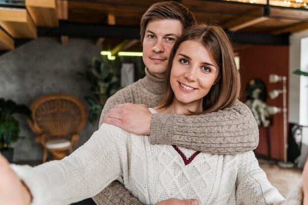 Beautiful woman taking a selfie with her husband