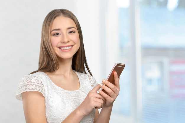 Beautiful woman texting on her cell phone