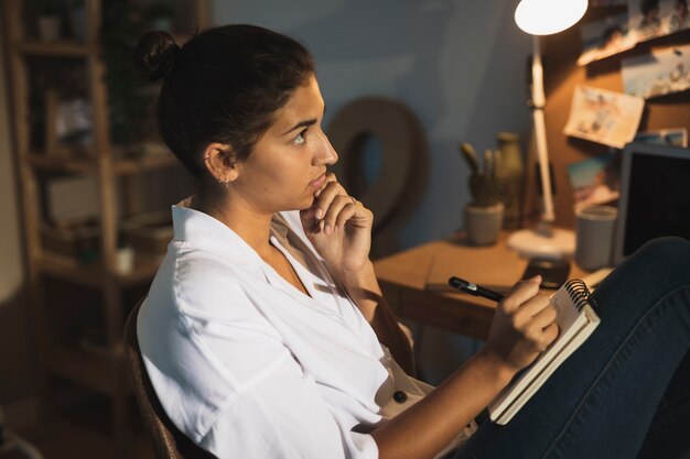 Beautiful woman thinking what to write