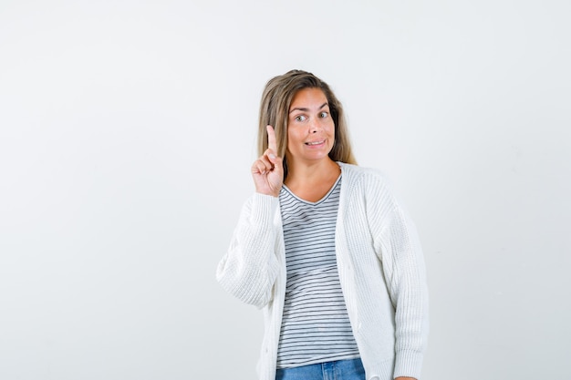 Beautiful woman thumb up in jacket and looking frightened. front view.