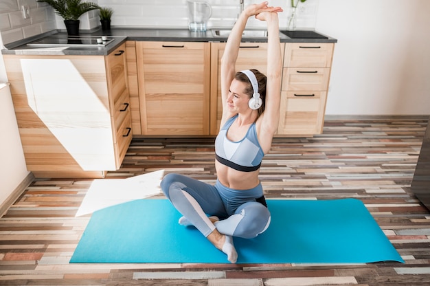 Beautiful woman training on yoga mat