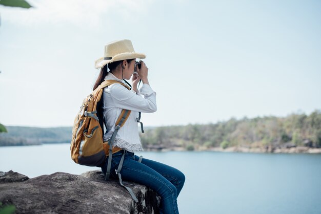 Beautiful woman traveler photographing temples 