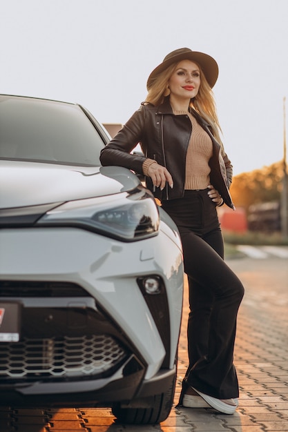 Beautiful woman travelling by her car