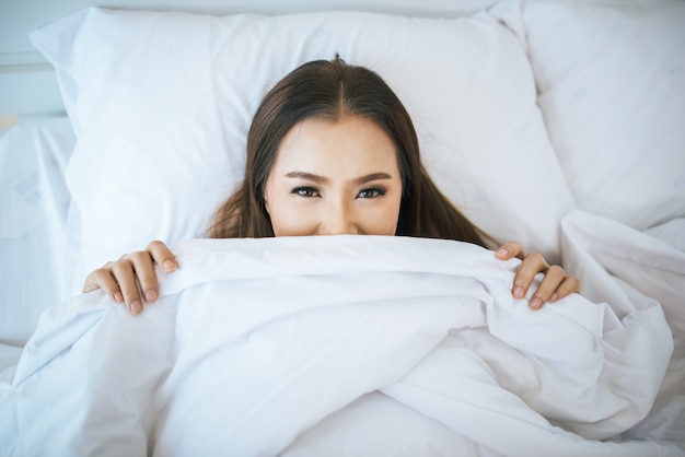 Beautiful woman waking up in her bed, Lazy in the morning