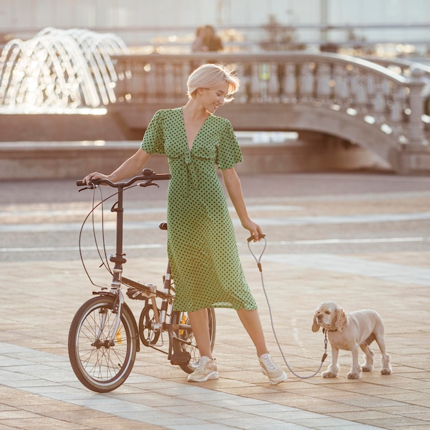 Free photo beautiful woman walking her cute dog