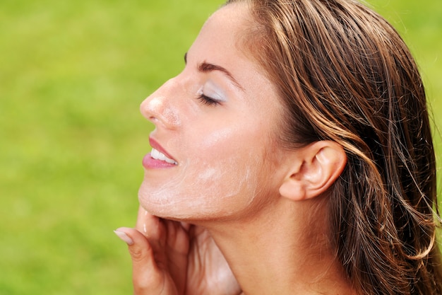 Beautiful woman washing her face