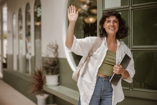 Beautiful woman waving at the camera