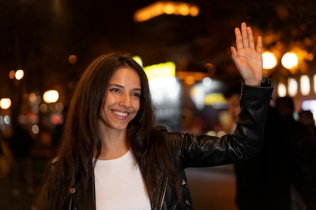 Beautiful woman waving at her friends