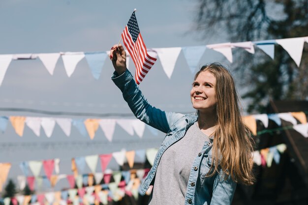 Beautiful woman waving USA flag at festival