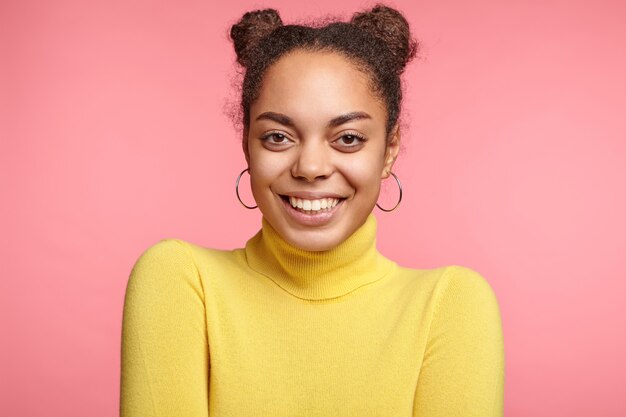 Beautiful woman wearing earrings and yellow sweater