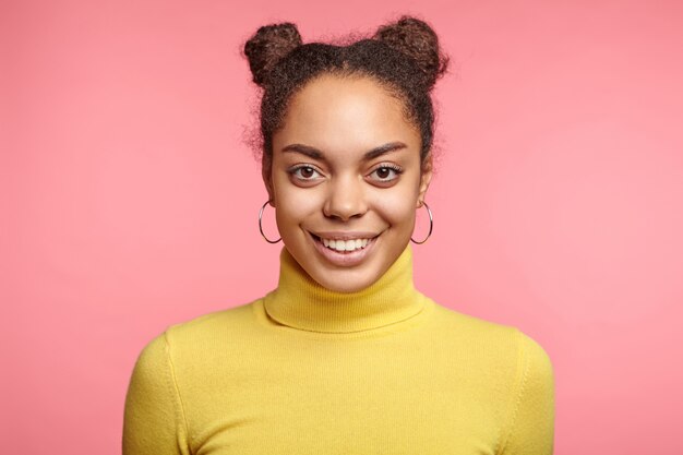 Beautiful woman wearing earrings and yellow sweater