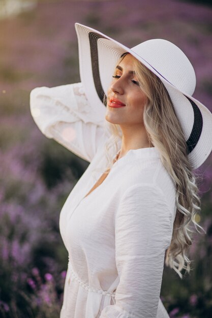 Beautiful woman in white dress in a lavander field