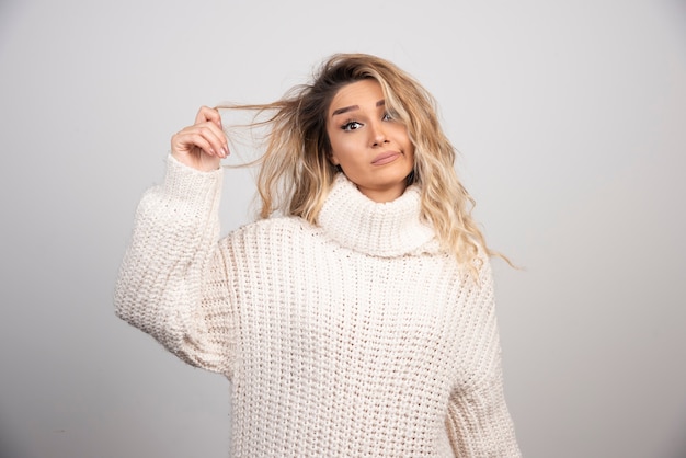 Beautiful woman in winter sweater looking at camera. 