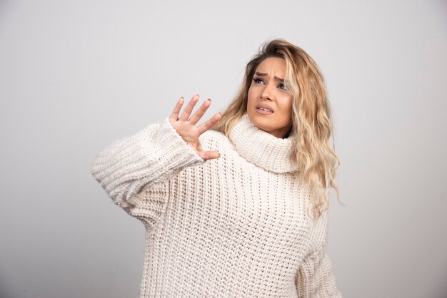 Beautiful woman in winter sweater looking somewhere. 