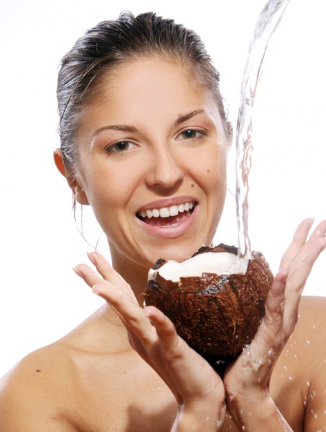 Beautiful woman with coconut in hands