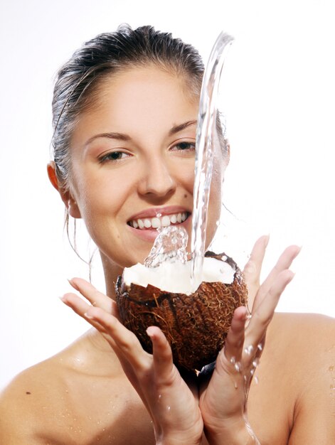 Beautiful woman with coconut in hands