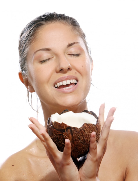 Free photo beautiful woman with coconut in hands