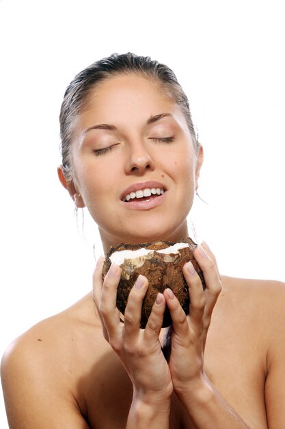 Beautiful woman with coconut in hands