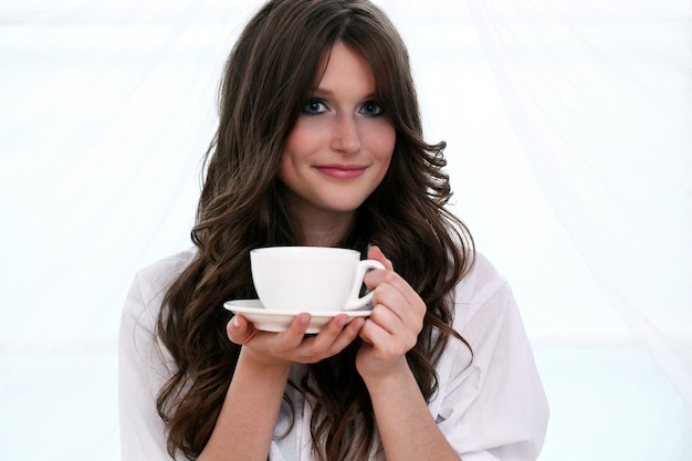 Beautiful woman with cup of hot coffe