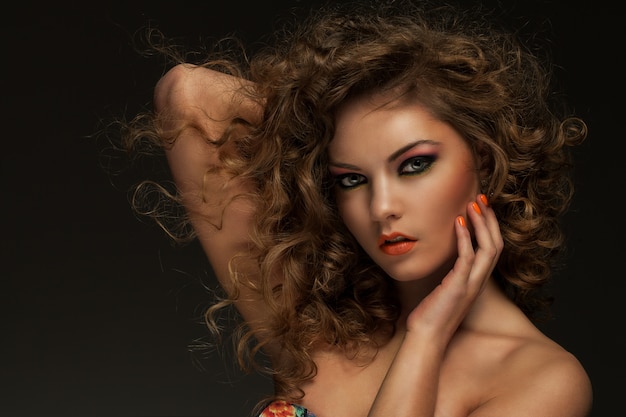 Beautiful woman with curls and makeup