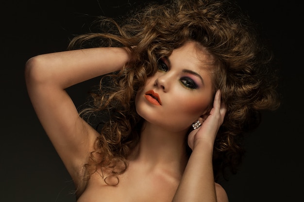 Beautiful woman with curls and makeup