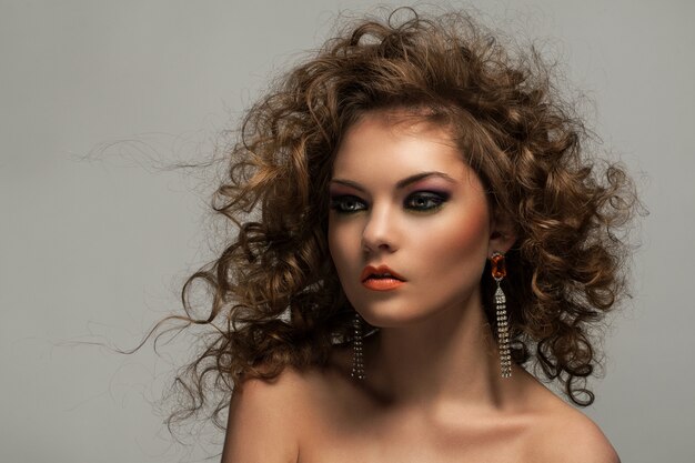 Beautiful woman with curls and makeup