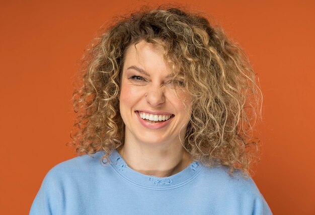 beautiful woman with curly blonde hair smiling