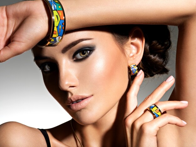 Beautiful woman with evening make-up jewelry and beauty fashion photo