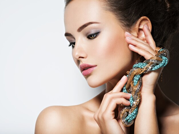 beautiful woman with evening make-up jewelry and beauty fashion photo