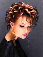 Free photo beautiful woman with fashion hairstyle and bright pink makeup posing.