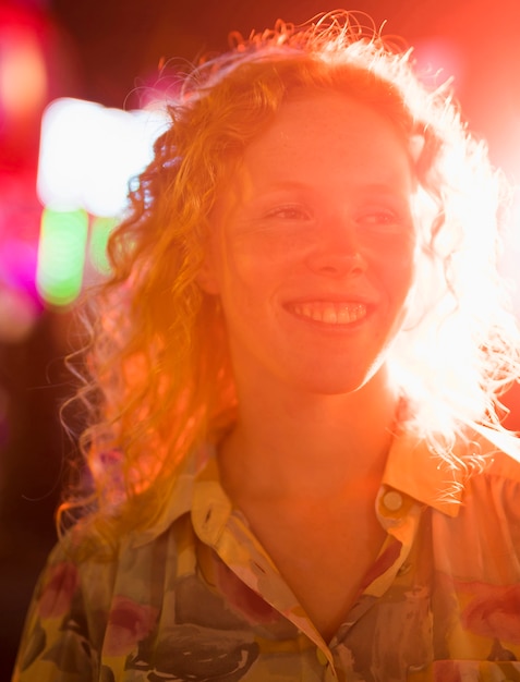 Beautiful woman with freckles at funfair