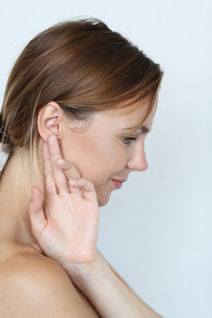 Beautiful woman with hand on ear