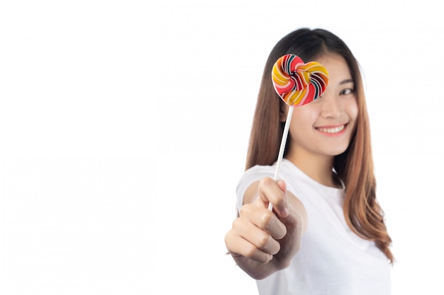 Beautiful woman with a happy smile holding a hand candy, isolated on white background.