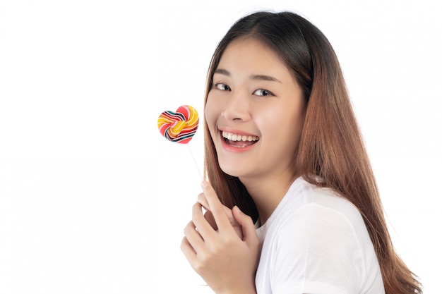 Beautiful woman with a happy smile holding a hand candy, isolated on white background.