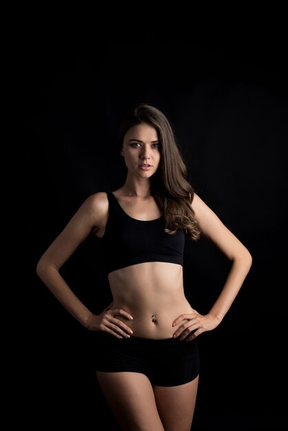 Beautiful woman with healthy body on black background