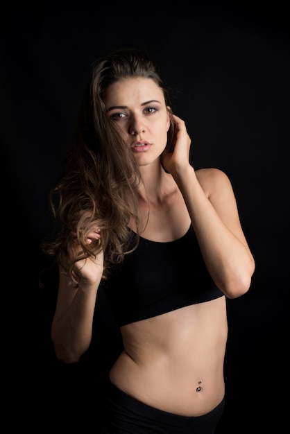 Beautiful woman with healthy body on black background