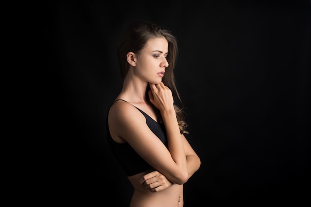 Beautiful woman with healthy body on black background