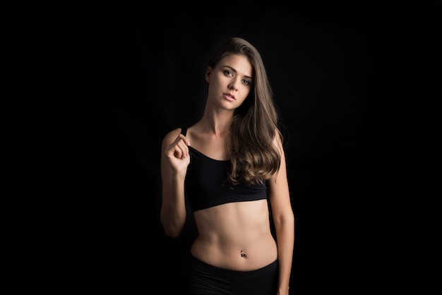 Beautiful woman with healthy body on black background