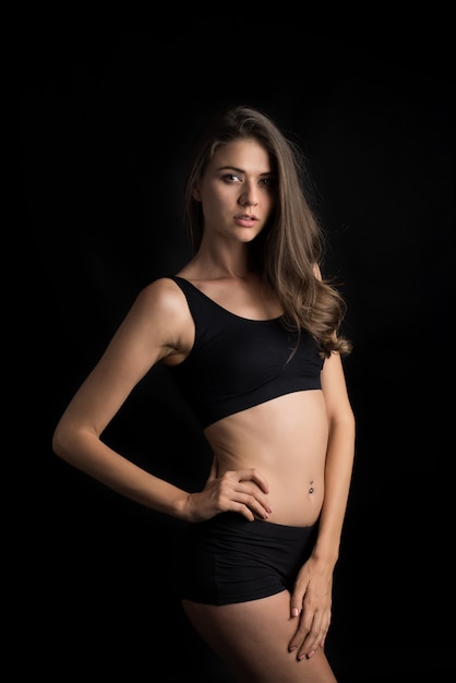 Beautiful woman with healthy body on black background