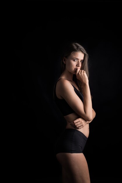 Beautiful woman with healthy body on black background